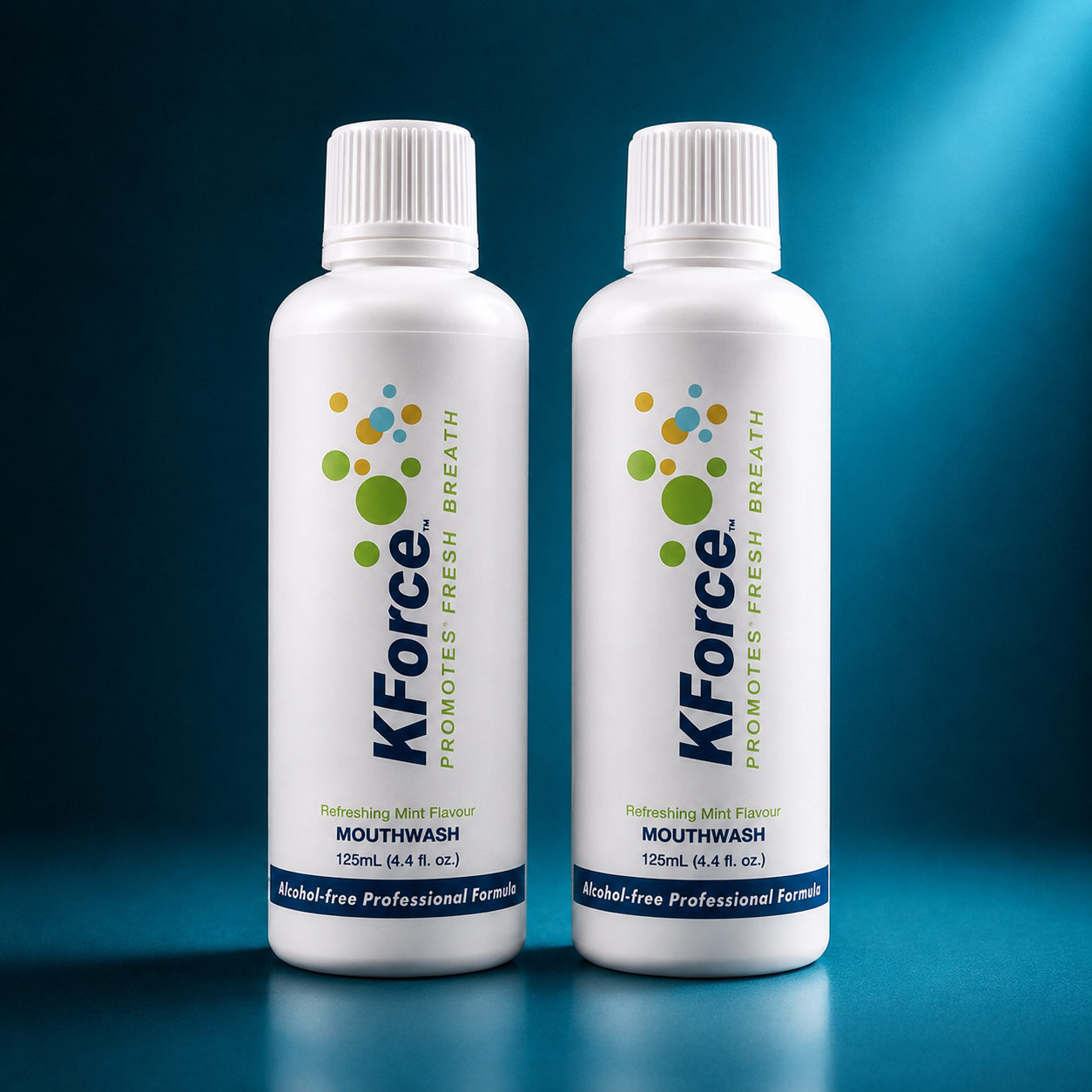 Two white bottles of KForce Promoting Fresh Breath mouthwash, 125mL each, standing side-by-side on a reflective dark blue surface against a dark blue gradient background.